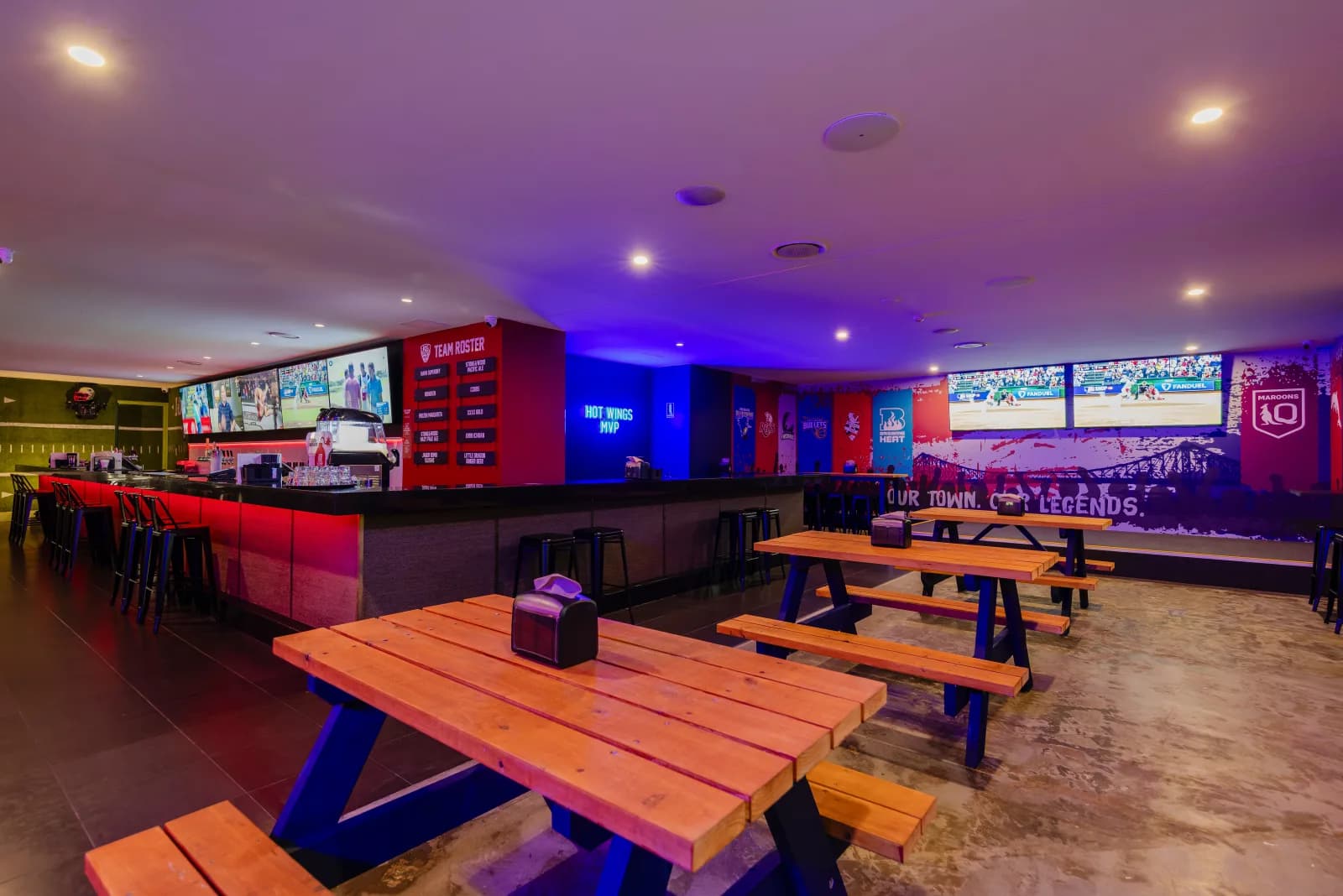 Group function tables facing the main live sports screens at KG Sports Bar